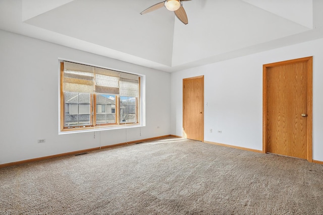 spare room with high vaulted ceiling, carpet flooring, visible vents, and baseboards