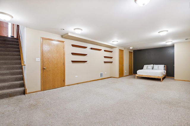 unfurnished bedroom with carpet, visible vents, and baseboards