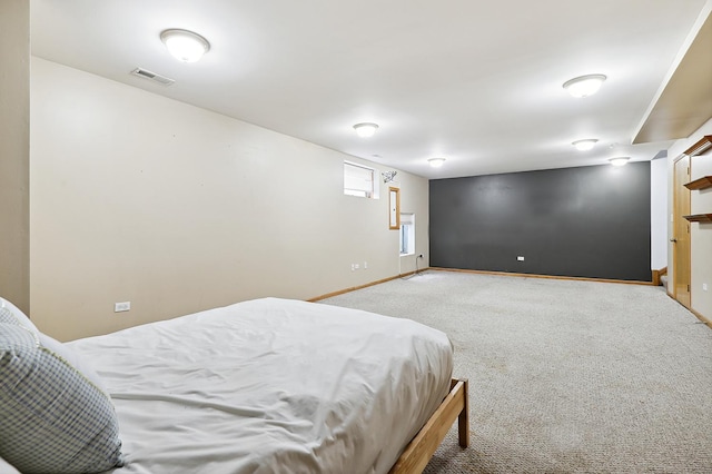 carpeted bedroom featuring visible vents and baseboards