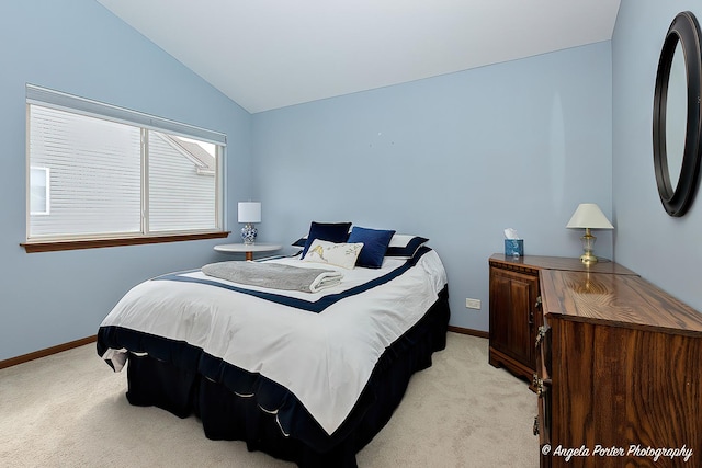 bedroom featuring light carpet, vaulted ceiling, and baseboards