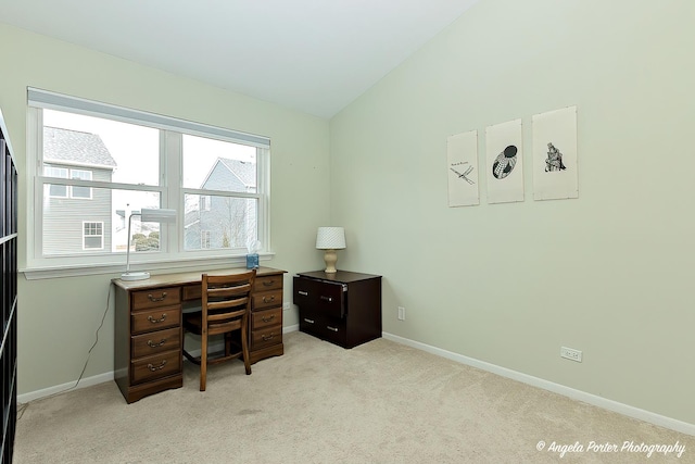 office area with lofted ceiling, light carpet, and baseboards