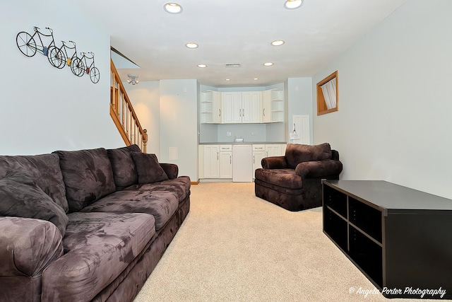 living room with light carpet, stairs, visible vents, and recessed lighting