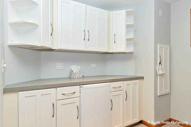 kitchen with baseboards, white cabinets, light countertops, fridge, and open shelves