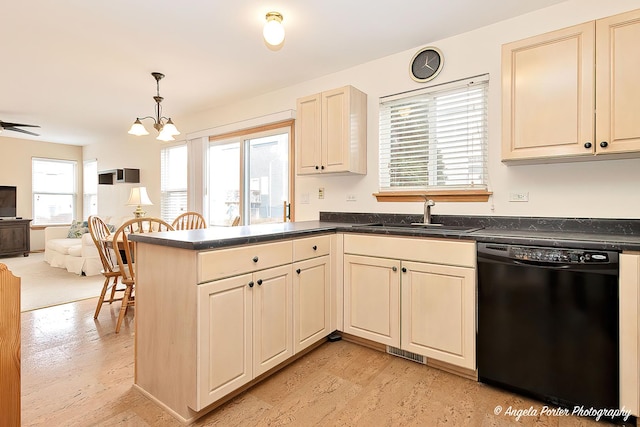 kitchen featuring a sink, cream cabinets, open floor plan, and dishwasher