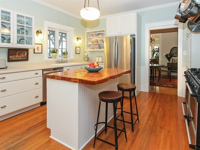 44W906 Berner Rd, Hampshire, IL 60140 - kitchen featuring wooden counters, appliances with stainless steel finishes, a breakfast bar area, and light wood-style floors