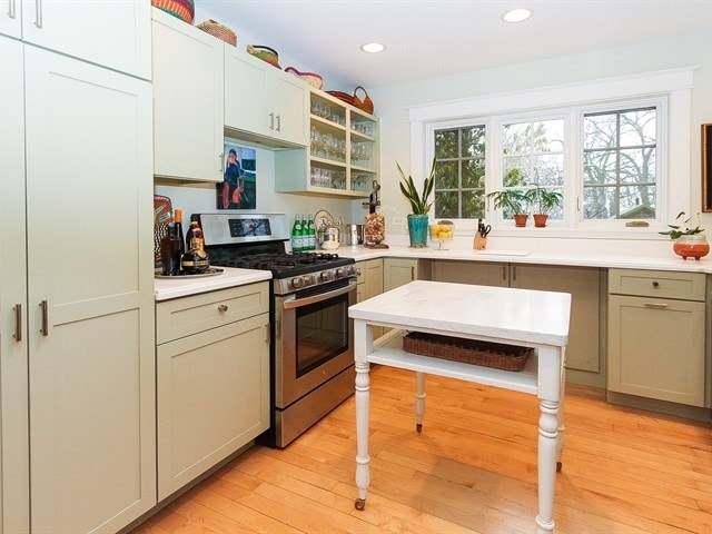 44W906 Berner Rd, Hampshire, IL 60140 - kitchen with stainless steel gas range oven, glass insert cabinets, light countertops, light wood-style floors, and recessed lighting