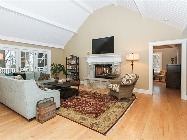 44W906 Berner Rd, Hampshire, IL 60140 - living area with baseboards, hardwood / wood-style floors, a fireplace, high vaulted ceiling, and beam ceiling