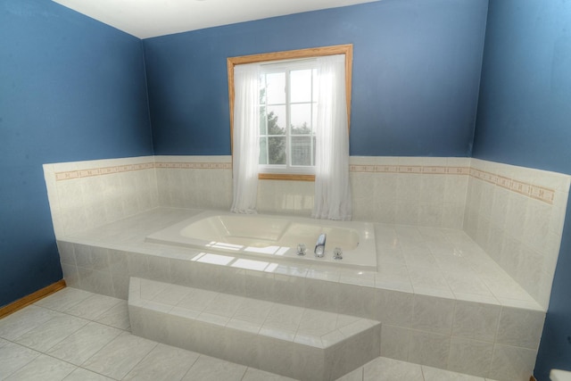 bathroom featuring tile patterned flooring and a relaxing tiled tub