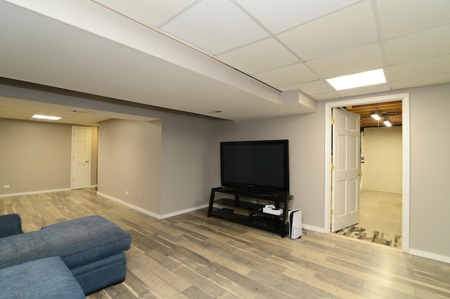 living room with hardwood / wood-style floors and a drop ceiling