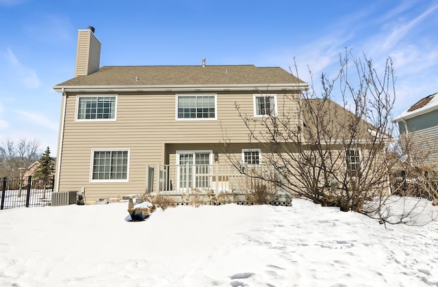 view of snow covered rear of property