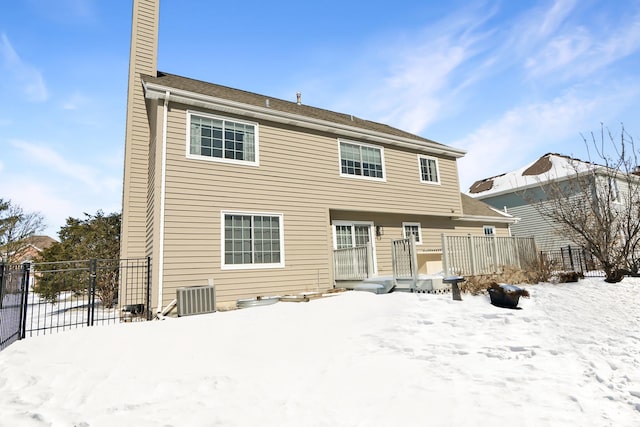 view of snow covered back of property