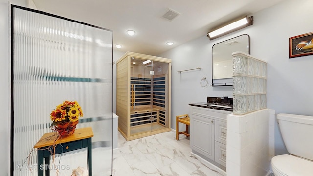 full bath with marble finish floor, visible vents, toilet, a stall shower, and vanity