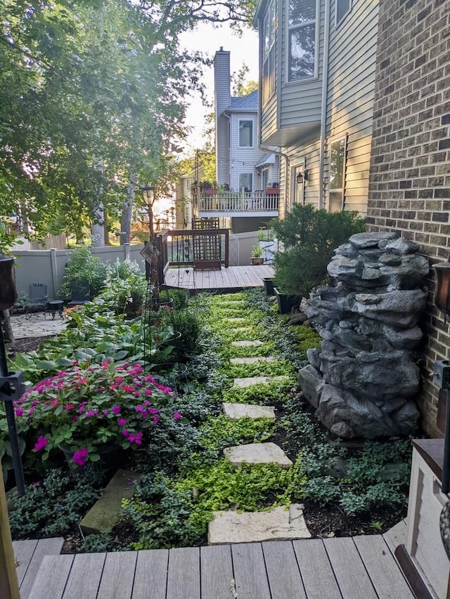 view of yard with fence and a deck