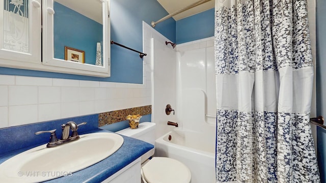 bathroom featuring toilet, shower / bath combo, tile walls, and vanity