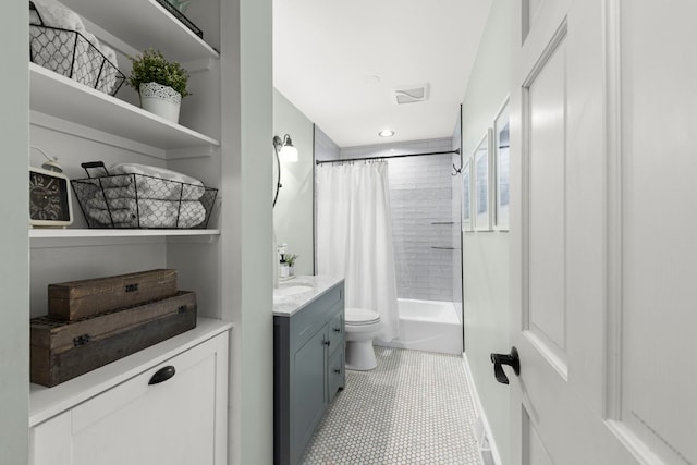 bathroom featuring toilet, visible vents, shower / bath combo, and vanity