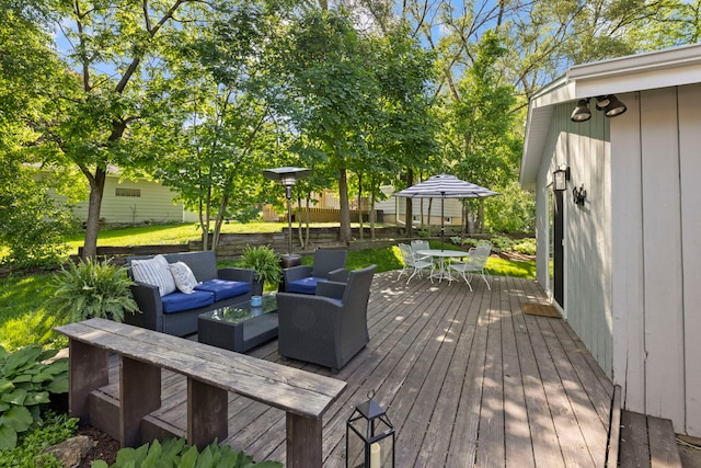 wooden terrace featuring outdoor dining area and outdoor lounge area