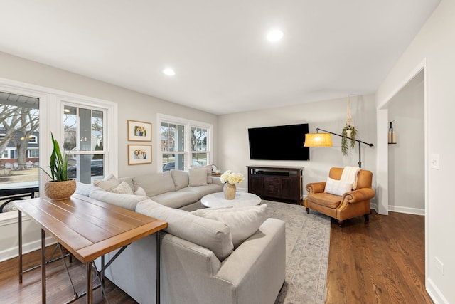 living room with baseboards, dark wood-type flooring, and recessed lighting