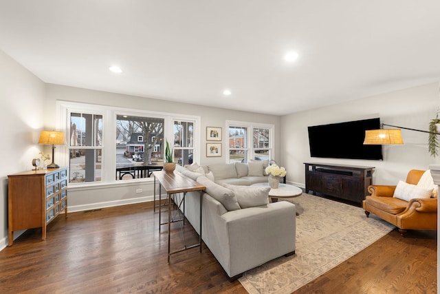 living area with dark wood-style floors, a fireplace, baseboards, and recessed lighting