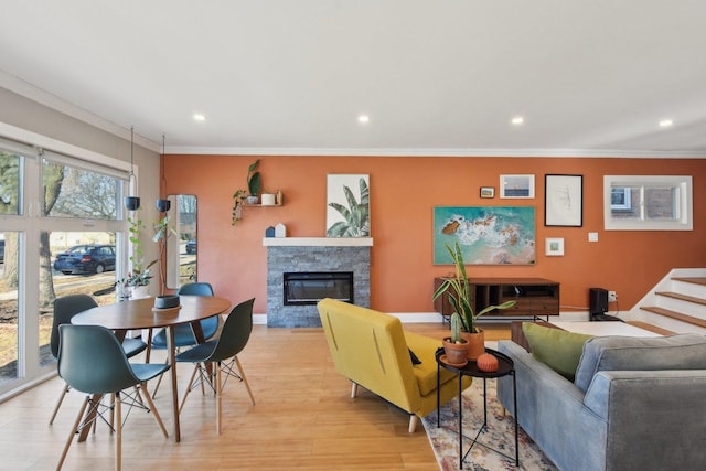 living room with light wood-type flooring and crown molding