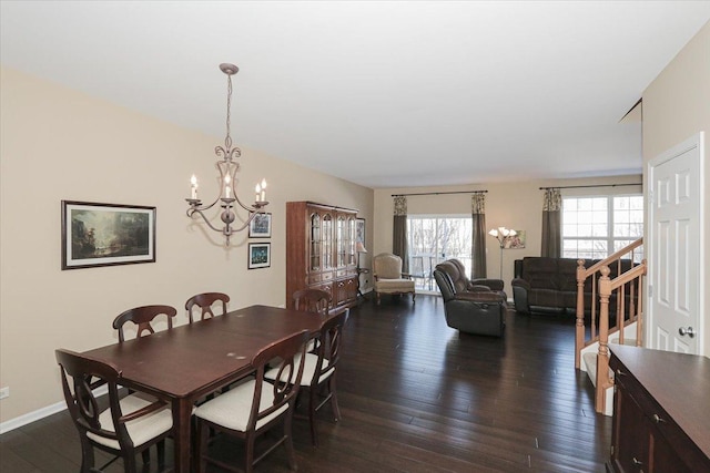 dining room with an inviting chandelier and dark hardwood / wood-style flooring