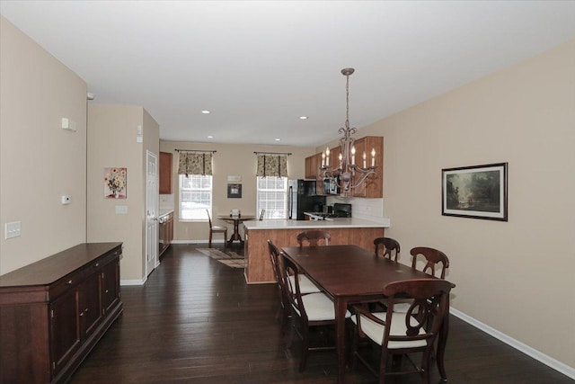 dining space featuring dark hardwood / wood-style flooring and a notable chandelier