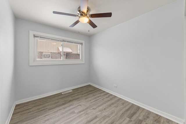 empty room featuring hardwood / wood-style floors and ceiling fan