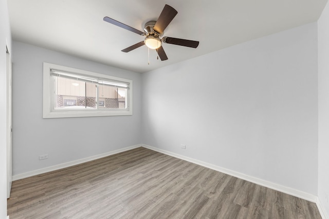 spare room featuring hardwood / wood-style flooring and ceiling fan