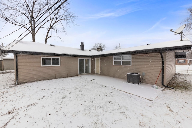 snow covered house with central AC