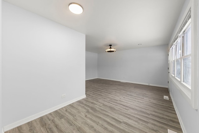 spare room with light hardwood / wood-style flooring