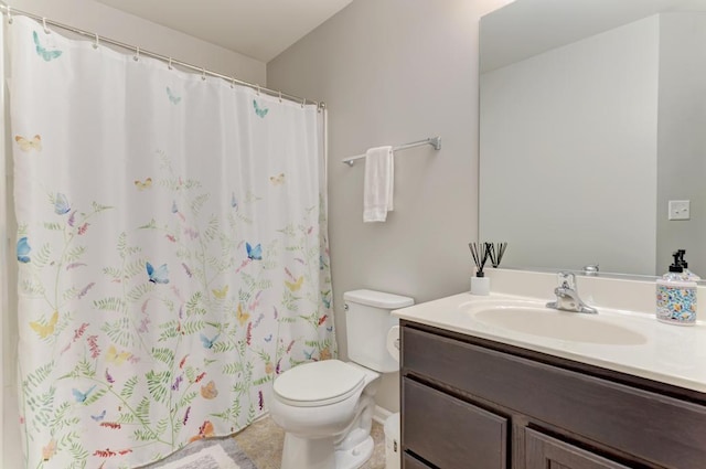 bathroom with toilet, vanity, and curtained shower