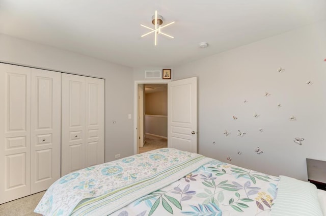 bedroom with a closet and light colored carpet