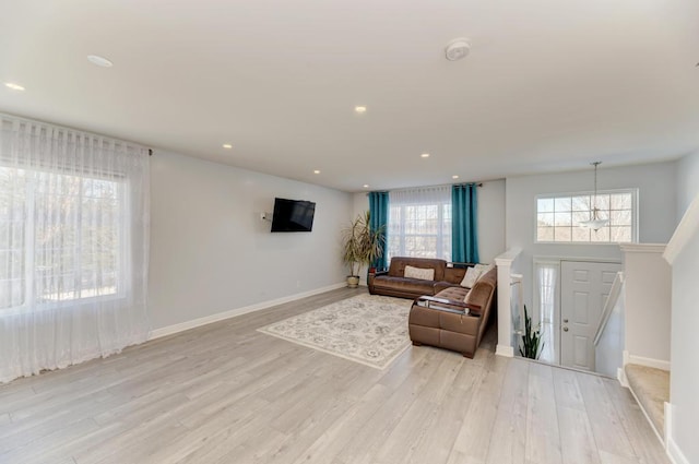 living room with light hardwood / wood-style flooring and a wealth of natural light