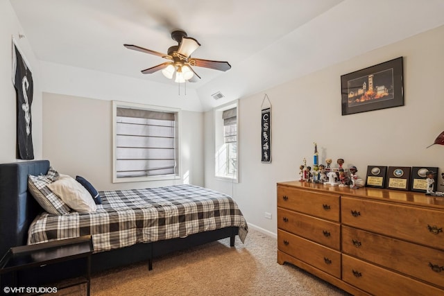 bedroom with ceiling fan, lofted ceiling, light carpet, visible vents, and baseboards