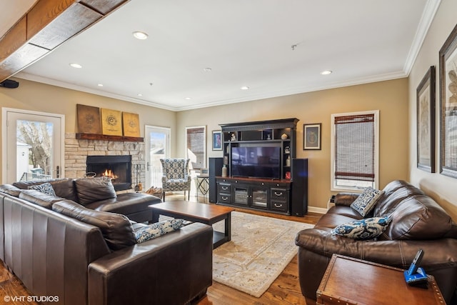 living area with a fireplace, crown molding, recessed lighting, wood finished floors, and baseboards