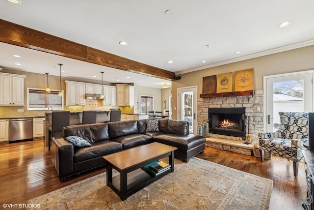 living area featuring recessed lighting, beam ceiling, and wood finished floors