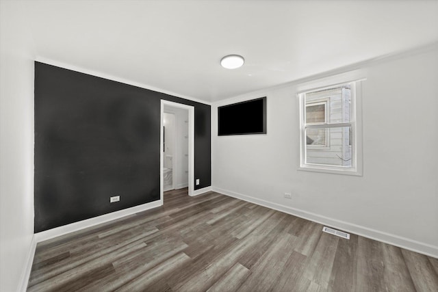 unfurnished room with hardwood / wood-style floors