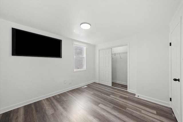 unfurnished bedroom featuring a closet and hardwood / wood-style floors