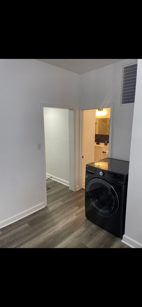 washroom with washer / clothes dryer and dark hardwood / wood-style floors