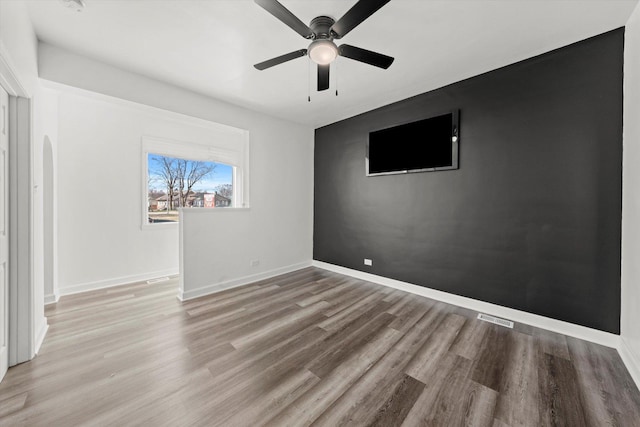 spare room featuring ceiling fan and light hardwood / wood-style flooring