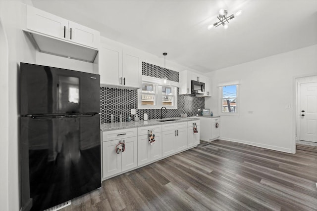 kitchen featuring sink, white cabinetry, pendant lighting, and black appliances