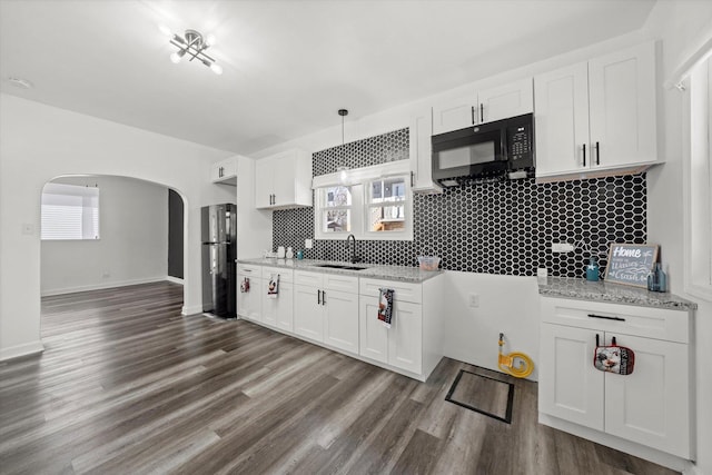 kitchen featuring white cabinetry and black appliances