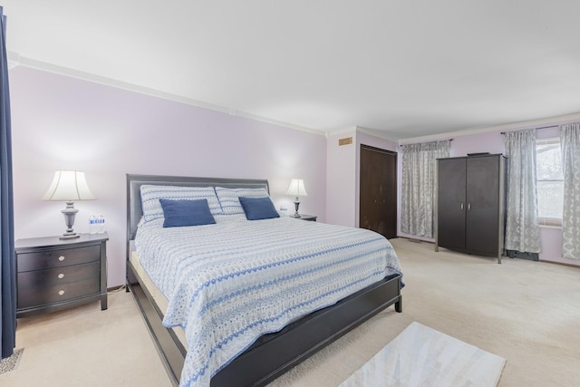 bedroom with light carpet, ornamental molding, and a closet