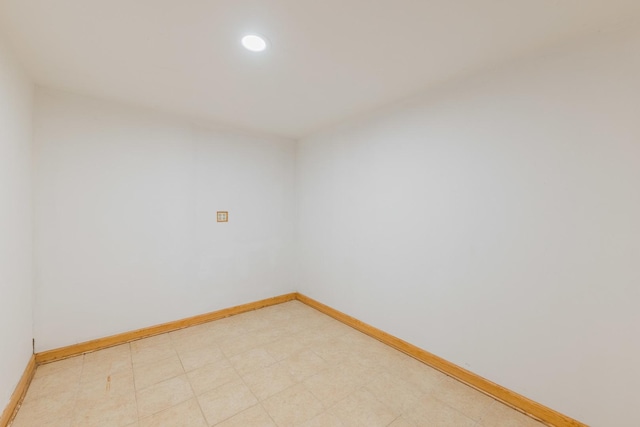 unfurnished room with light floors, recessed lighting, and baseboards