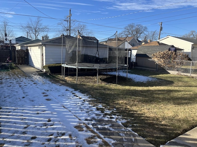 exterior space with a trampoline and a yard