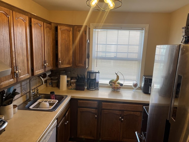 kitchen with sink, backsplash, stainless steel fridge, and dishwasher