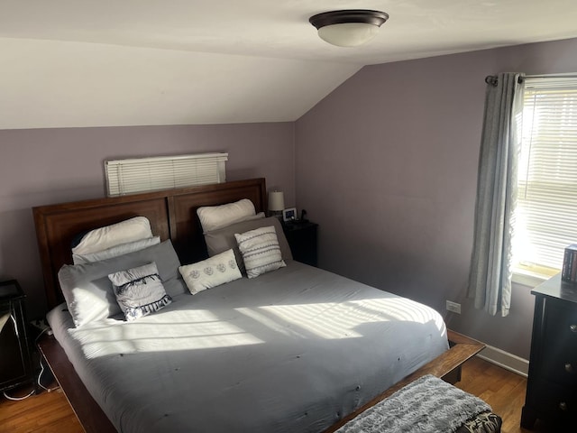 bedroom featuring hardwood / wood-style flooring and vaulted ceiling