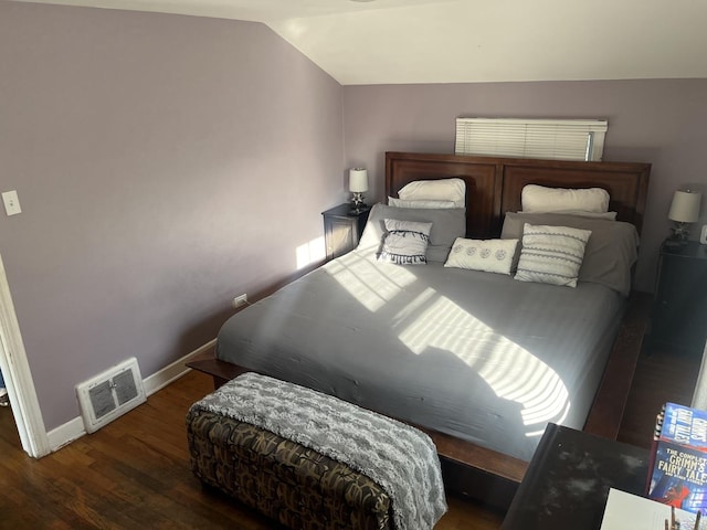 bedroom featuring lofted ceiling and dark hardwood / wood-style floors