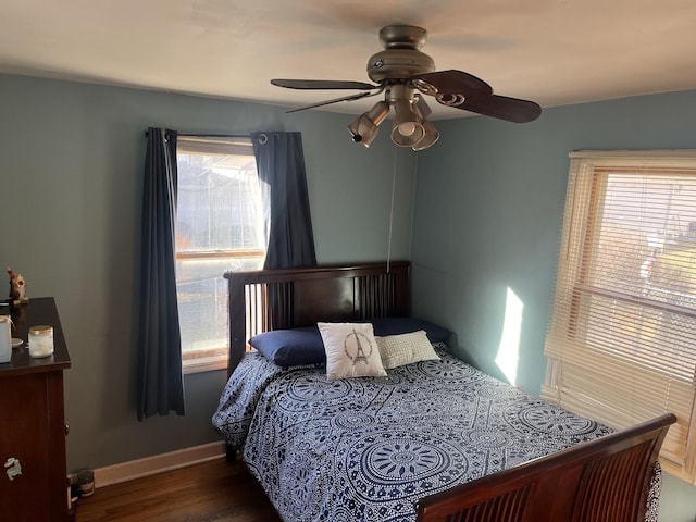 bedroom with ceiling fan and dark hardwood / wood-style flooring