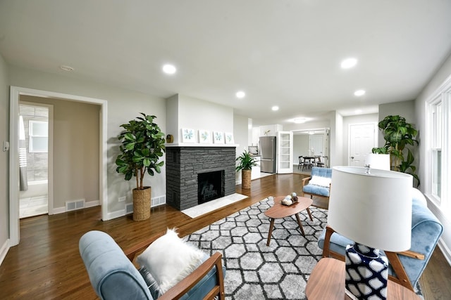 living room with a fireplace and dark hardwood / wood-style floors