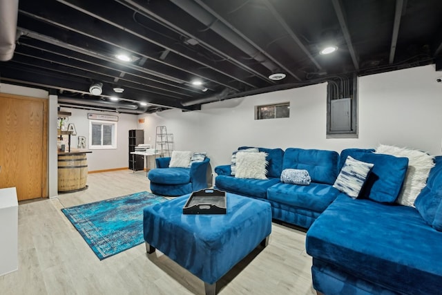 living room with hardwood / wood-style flooring and electric panel